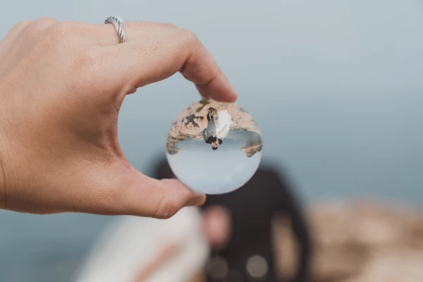 The crystal ball serves as intermediate object, not only reflecting the purity of love but also capturing the moment of eternality. Keeping the proper distance while taking focus on the crystal ball is the key to take this photo successfully.