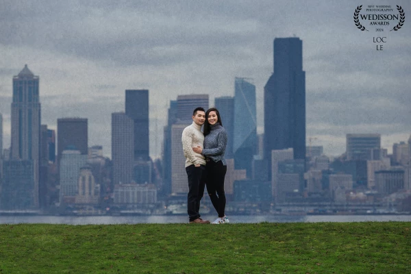 The image blends urban sophistication and heartfelt romance, capturing the essence of Seattle's skyl...