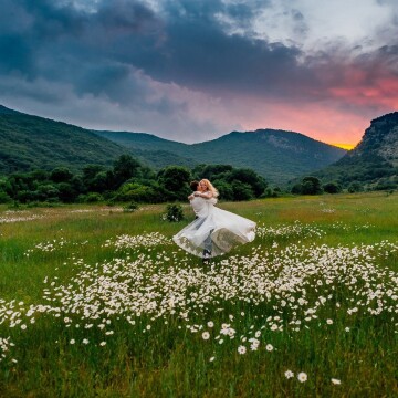 The photo shows the beautiful dance of the bridal couple. Tatiana Bride flies into the arms of her Michael. Sunset sky and wonderful nature of Crimea are the perfect backdrop to this action! Their love is full of vivid colors and aromas of wild flowers!