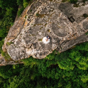 This photograph was taken on a scenic plateau Mangup Kale. Newlyweds Michael and Tatiana are high in the mountains, couple in love looking at the endless sky ... They seem to give a boost to their feelings for each other and hover over all the world.