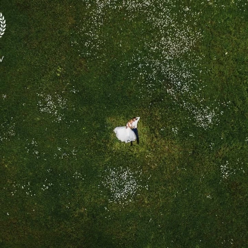 This image was shot in the foothills of Mangup Kale. Green juicy grass and white daisies are the perfect bed for the newlyweds. Mikhail and Tatiana inhale fresh air. Their sleep undisturbed. Harmony!