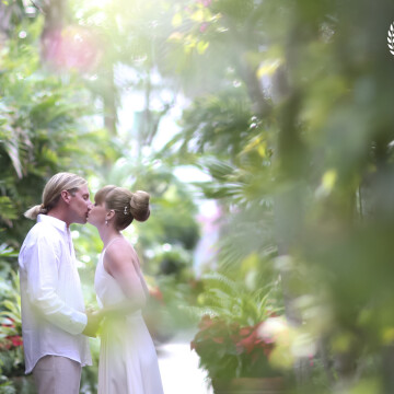 <br />
This photo was taken using an 85mm prime lens in natural light. I framed the couple by photographing through some floral vines that dresses the walkway. <br />
<br />
<br />
