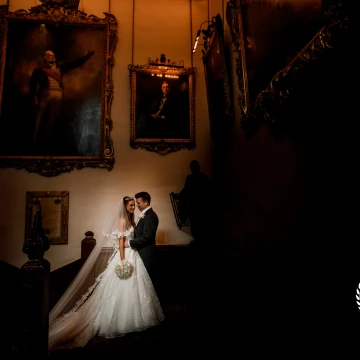 Sam and Elena's London wedding at the Ironmongers Hall near Barbican. <br />
A newlywed photo in the natural window light from the grand staircase.