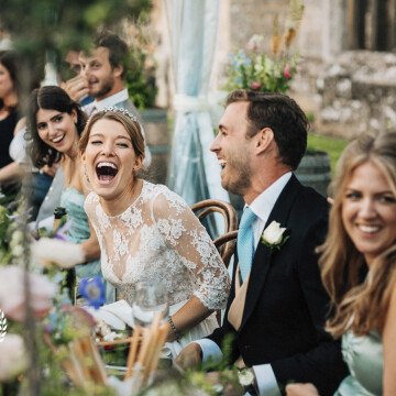 The fabulous Emerald laughing uncontrollably at her (now) husbands wedding speech, alongside guest at Cowdray Ruins in Sussex. This was inside the stunning ruins at Cowdray Heritage and a beautiful wedding.
