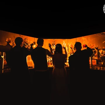The bar at the hotel had an interesting shape so I added some full CTO gels to my flash and created a silhouette shot of the bridegroom and friends raising a glass to happiness.