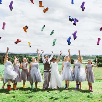 One of my most fun weddings to date, everything was like a festival, sitting on straw, food fans and ice creams, what a wedding. We just did the formal group shot of the girls and thought let's get funky with it, girls dancing throwing the wellies in the air? Of course, they were game.