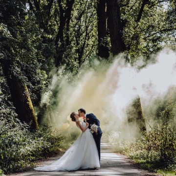 This image was taken last summer in Belgium. We are always chasing the light. The light was peeking through the trees, so it was the perfect moment to use a smoke bomb. 