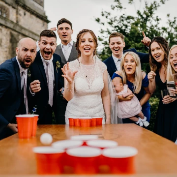 Beer Pong at a wedding - Great Idea! Especially when the bride nails it in the corner cup. Get chugging those beers, boys! The reaction of the guests is priceless!