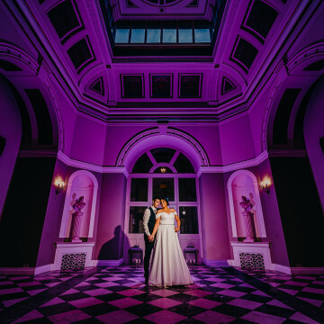 Shot at Lartington Hall in Barnard Castle, the venue is sublime. This is the entrance to the venue and knew it would make for a great creative portrait. I used a key light for the bride and groom and a magenta creative gel behind them to light the room.
