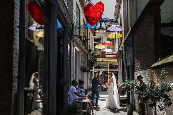 This couple was getting married on a very hot summer day in the city of Deventer in The Netherlands. During there wedding there were festivals in the City. There were umbrella’s in the streets and a lot of nice colors. They decided to just walk around the Beautiful City and enjoy there summer wedding day.