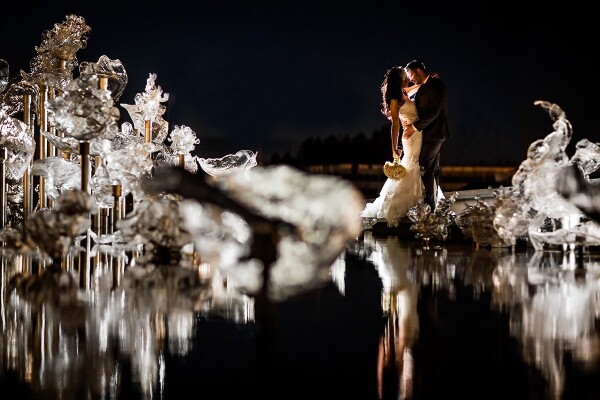 This couple wed in Seattle, WA and really wanted some romantic photos at night after the wedding day was over. We headed over to the Tacoma Glass Museum, and as soon as I saw these gorgeous glass statues sitting in water, I got down on the ground to get a stunning reflections of all the glass structures, as well as a reflection of the couple as they shared a kiss.