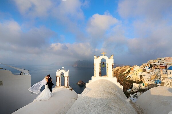 Everywhere you look in Santorini, Greece is breathtaking! Waking up for a sunrise shoot to catch some lovely light was totally worth the effort, and we had the early morning quietness all to ourselves without all the hustle and bustle of tourists as seen during the day and/or during sunset time. This couple was up to anything for a photo, including climbing on curved rooftops for the perfect shot. 