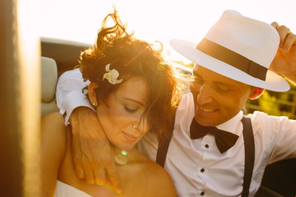 This photo was taken during an intimate moment between Mariella & Jose. We were driving a convertible car during sunset from the ceremony to the reception and I was in the front seat waiting for them to relax in order to start capturing their true love. Their wedding was in Sicily, an island very famous for its amazing sunsets!