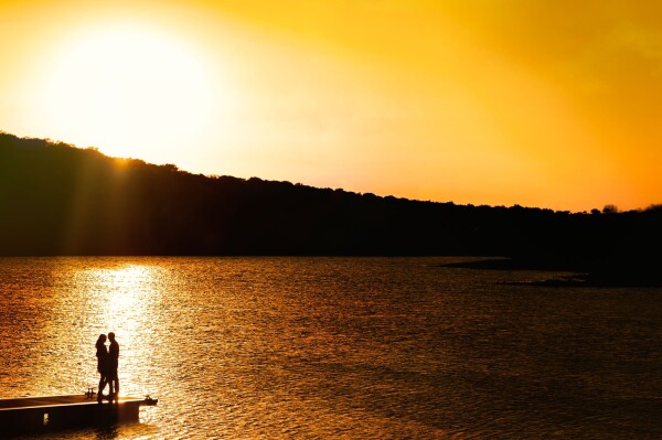 A sunset over a lake and a couple in love was enough to create the image of movie ..