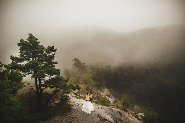 Bernard and Mitja decide to do a photoshoot, on their special day a little different as usual. Mitja had planned this wedding adventure months before the big day and we decided to take shooting of bride and groom in Slovenian mountains very close to their home but none of us expected that on this special day will be raining like hell. Fog, rain and wind create this beloved atmosphere of a couple up high.