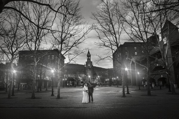 Jamey & Seanna Gifford of Lawrenceville, PA chose to have their wedding photographs taken in The Gaffer District of Corning, New York. They stayed at the famous Radisson Hotel, which is a short walk to Centerway Square where this clock tower serves as a gathering place for the community since it’s reconstruction in 1989 as a city park. The clock tower was originally constructed in 1883 and was a gift of heirs of the community’s founder, Erastus Corning. This location was the perfect backdrop to document their special day and especially in the month of February in Upstate New York where the winters can be cold and gray. The beautiful lighted brick walkways make it a romantic place to capture special moments like this, moments where they walk together on their new journey as husband and wife. Thank you to you both for choosing Betsy Snyder, Simply Time Photography to capture these special memories for you! Finger Lakes Region of New York Wedding. Photographer @simplytimephotography.