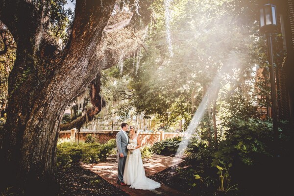 Patti and Bobby got married at the beautiful St. Lukes, in downtown Charleston.This image was captured right after their ceremony in the courtyard of the church.  The suns rays were filtering through the leaves of the giant oak trees, framing the couple for this portrait.
