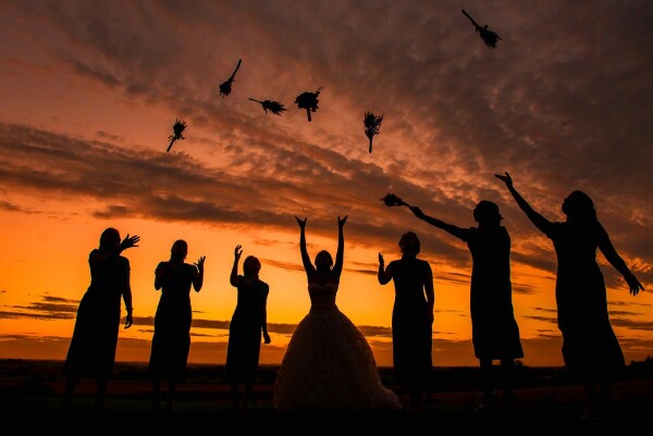 This photograph was taken at sunset at a wedding at West Tower in the North West of England. I wanted to do something different with the girl's silhouettes so asked them all to throw their flowers in the air at the same time.