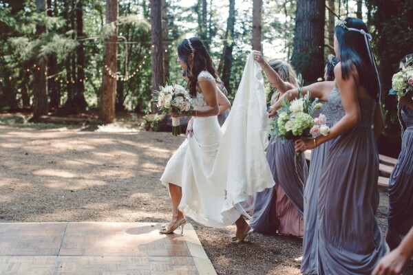 The majestic California redwoods captured the grandeur of the day and also set the backdrop of the wedding. She was happy, with her bridesmaid around she felt complete. They were her best friends, her sisters, her girls! This moment of helping her captured.