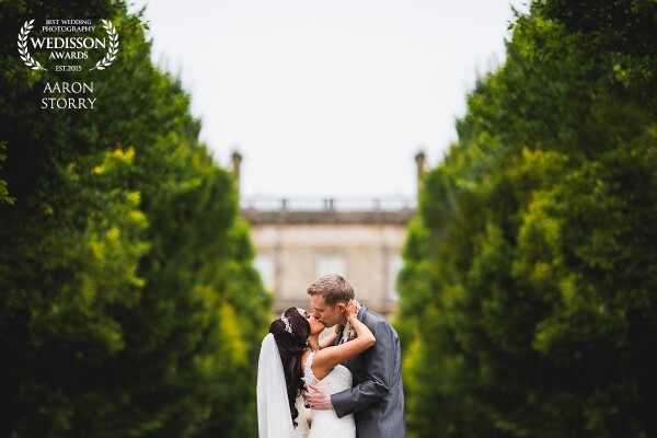 It was getting towards the end of a 2 day fusion wedding and everybody was feeling the love (and slight fatigue!). As we walked back from a mini portrait shoot I noticed the stunning symmetry at Hedsor House, I asked my couple to share a moment and this is what happened next! 