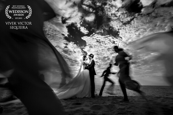 Shot near beach in Mangalore, Karnataka,India. Dramatic Cotton clouds with awesome location gave a perfect background which i was looking for. Crazy friends of bride & groom Daphne & Denis created the mood of this image.