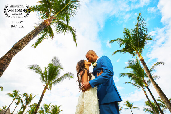 A slight tropic thunderstorm in the Dominican Republic rolled in after the ceremony which almost put a damper on photos but the couple enjoyed cocktail hour and as soon as the storm passed we popped out of the event cover and snapped this great moment. Of course I had to lay in the wet grass to make it happen and get rid of all the resort distractions and buildings behind them! Would do it again in a heartbeat! Loved this trip and couple! So much fun! 