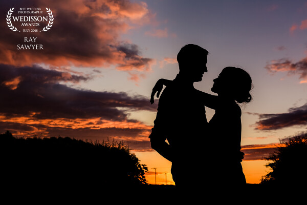The sun was setting fast and Hollie and Aidan were inside ripping the dance floor up with their guests. I had mentioned doing a sneak out so they popped outside for 5 minutes, stood near the entrance to a farmers field overlooking the gorgeous sunset. As soon as i posed them I knew it would make the perfect silhouette.