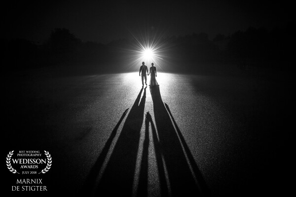 When driving up to this location (a huge parking lot without markings), I already saw this shot. Love it when couples allow me to take some non-traditional shots at their wedding. We waited until after sunset and then shot this from a ladder with a 16mm lens to enhance the effect of the shadows.