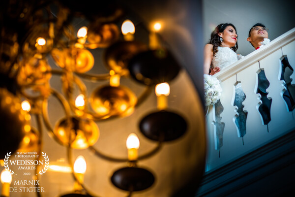 This was just before this couple went downstairs to walk into the big hall with all their friends and family for the ceremony. This place had beautiful chandeliers which warm light contrasted nicely with the cooler natural light which fell on the couple.
