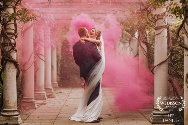 Jess & Owen were a dream to work with! I loved the composition in-between the columns & wisteria, I added a smoke bomb for a little drama, then let them to get tangled up in love <br />
Venue - Bedford Lodge Newmarket.