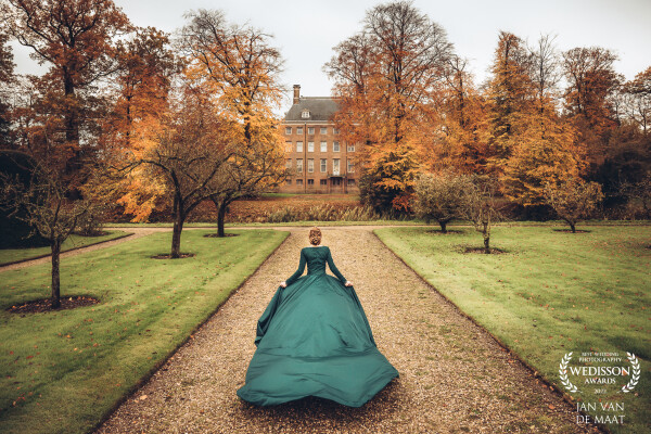 The mother of the bride has made this beautiful emerald green dress. It was mid november and autumn was showing full color. I tried to let the bride run a bit to see the long dress was floating behind her. That worked out beautiful so I decided to let her run again and I stood upon a small staircase and made this image. It looks like a cover of a novel is the comment I receive a lot at this image.