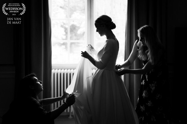 This wedding was very special for me because it was in Denmark and I could not speak or understand Danish. But everyone could speak English as well and so I could ask a few girls to help the bride with her preparations for her big day. I placed them just in front of the window to get this beautiful classic image.