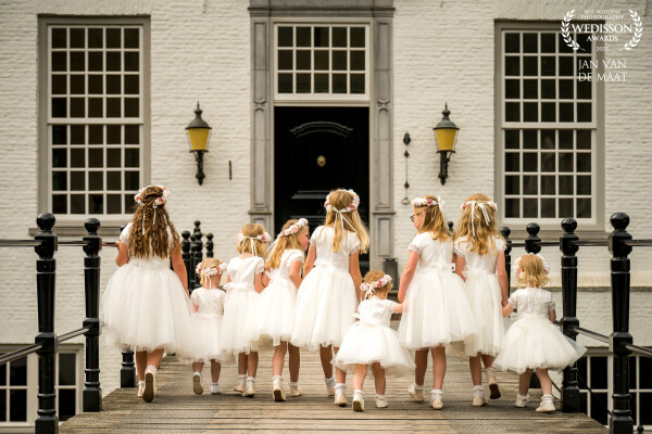 Nine out of original ten flower girls walking towards the white castle where the wedding would take place that day. I had some extra time with these girls only so I let them hold hands and told them simply to walk away from me. A nice detail; all dresses of the flower girls are made by the mother of the bride, who is coupeuse/designer of wedding dresses.