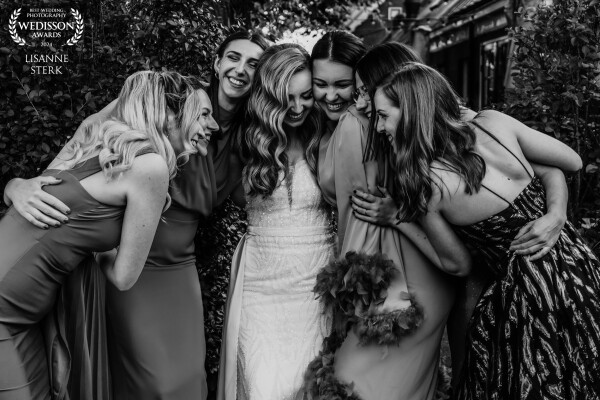This photo is full of love and friendship, a warm group hug with the bride and her best friends. Ver...