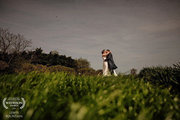 A low angle was perfect to capture Sabrina & Matt having a little smooch and kiss after their wedding ceremony at Bassmead Manor Barns.