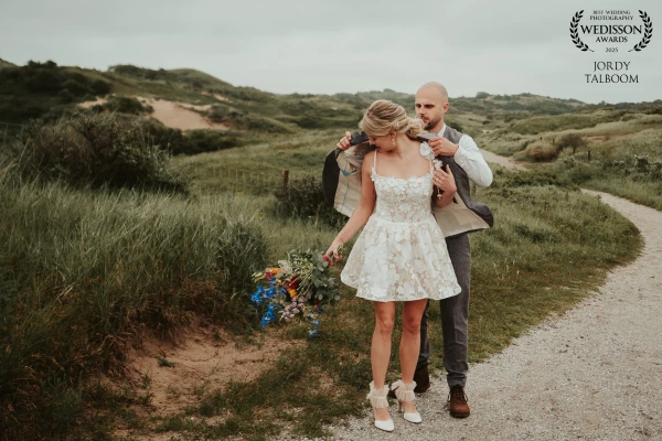 An intimate and loving moment captured in the dunes of Katwijk aan Zee. This photo highlights not on...