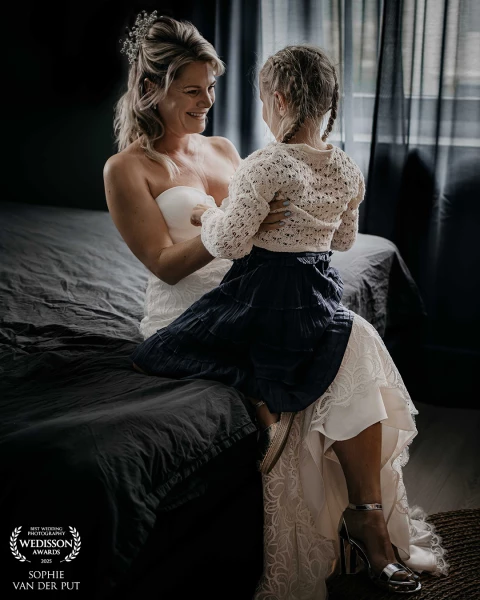 A loving and heartfelt moment just before the first look: the bride shares a special connection with...