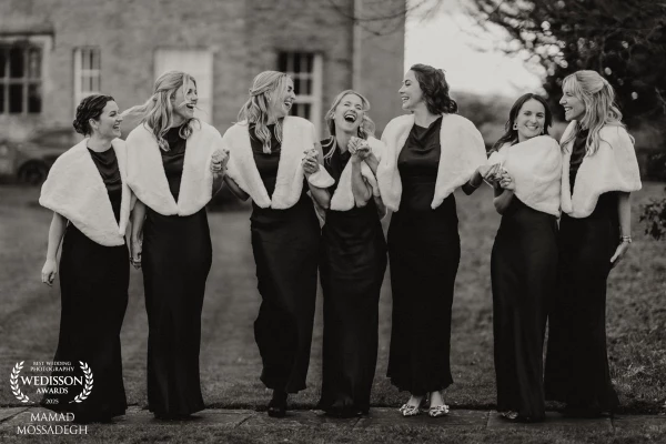 The bridal party get excited waiting for the arrival of the bride outside the church.