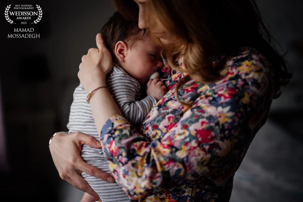 A precious moment between a new mother and her baby, as he falls to sleep in her arms after a feed.
