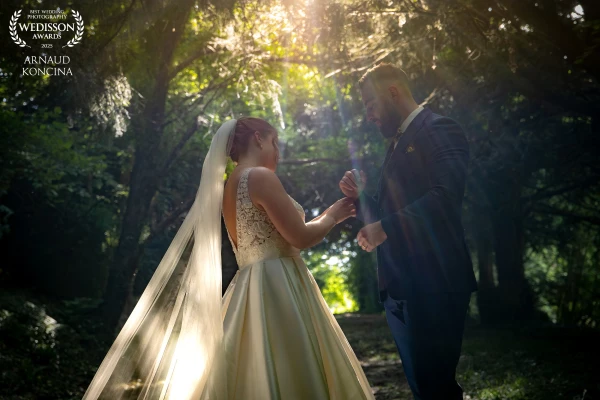 The newly weds enjoying a quiet moment in the woods during the wedding day.