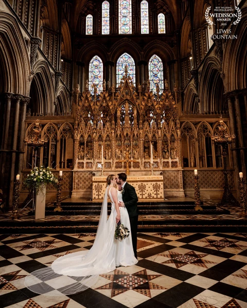 Fiona and Jared sharing a kiss at the altar inside the stunning Ely Cathedral. Couldn't ask for a better backdrop for this moment.