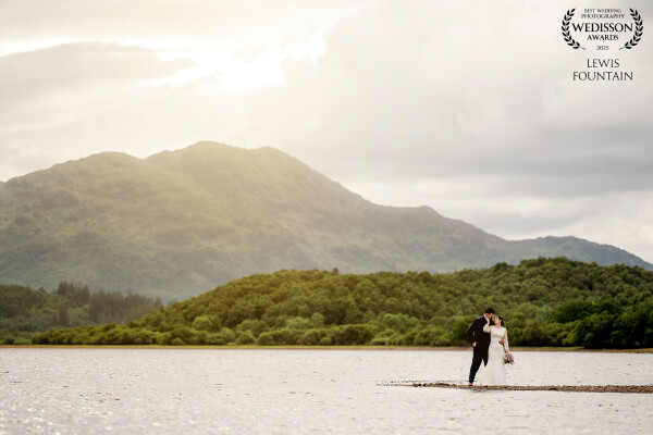 While exploring the lochside with Emily and John, we spotted this narrow stretch of land that jutted out into the lake. It gave the illusion they were completely surrounded by water, with the mountains adding such an epic backdrop. We took a few steps back, gave them a quiet moment together, and let the landscape do the rest.