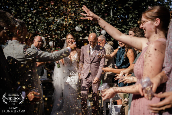 Lotte en Tom lopen onder luid enthousiasme en gedroogde bloemblaadjes weg bij hun ceremonie <3