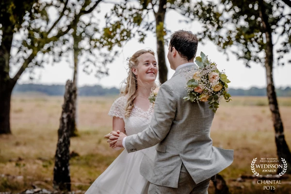 Between the trees, in the gentle light of nature, they shared a moment where time seemed to stand st...