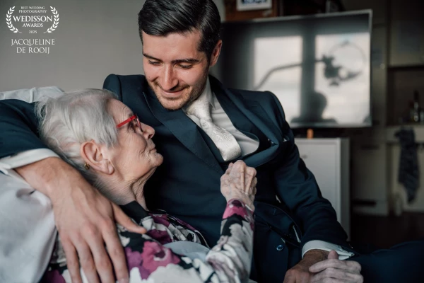 Such a beautiful quiet, intimate moment during the wedding day. The groom shares a tender embrace wi...