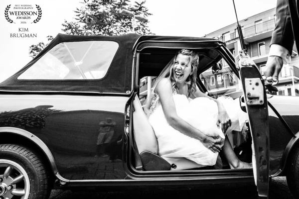 Small car, big dress, even bigger smile