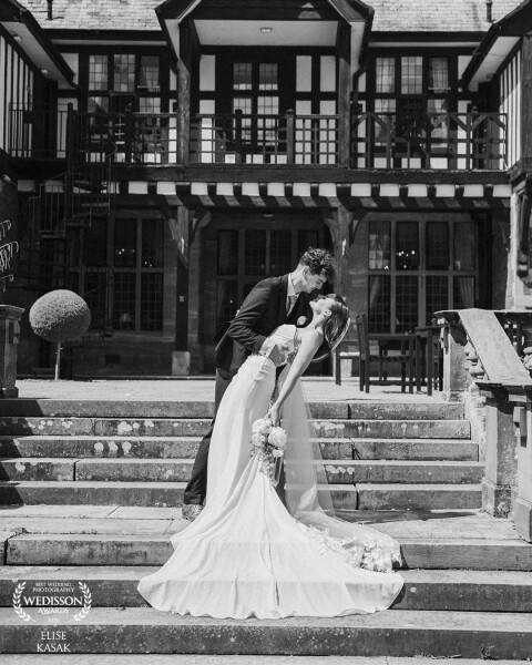 A timeless black and white portrait, framed by the charm of beautiful English architecture. 🤍