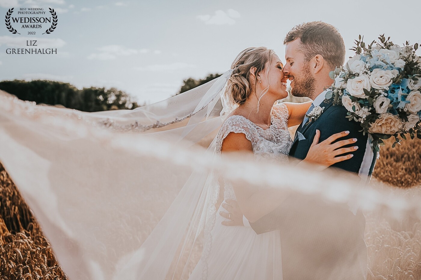 We had been taking photos in the corn field when the wind whipped the veil around the couple. It was a gorgeous moment that we made the most of