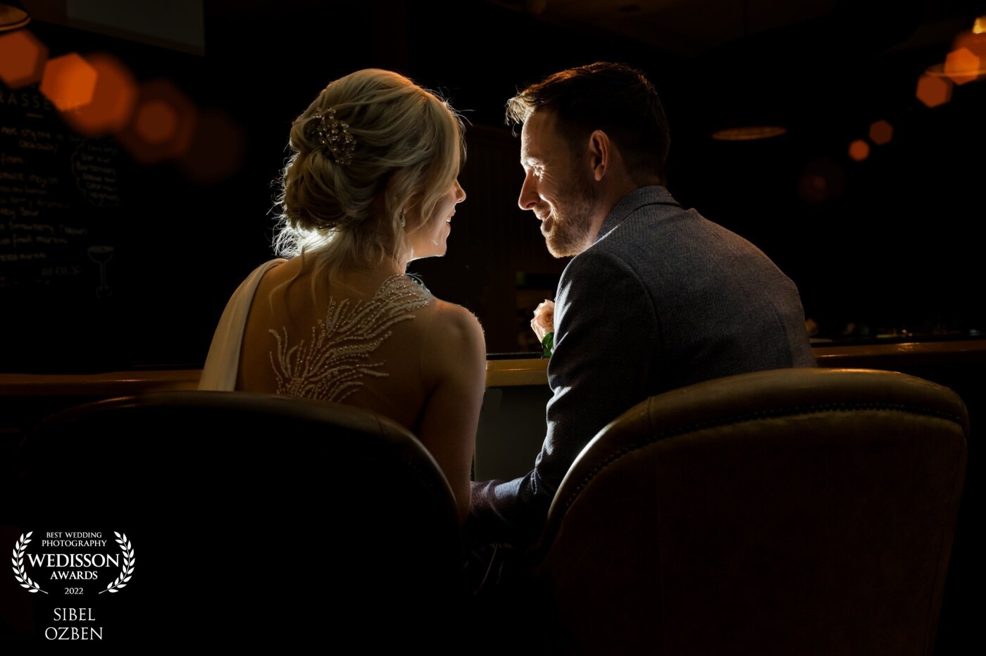 This romantic moment was captured just before the bride and groom entered to their dining room.  They set at the bar having a quite romantic moment to themselves.