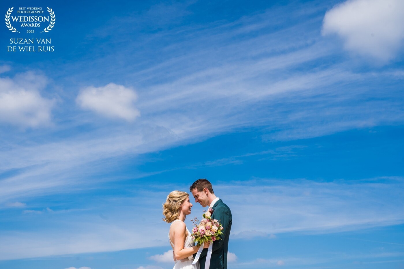 We just love beautiful bright colors in our wedding portraits. This beautiful sky and the gorgeous couple really pop, we used a little flash to keep the vibrant blue of the sky.